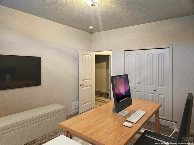 home office featuring visible vents and a textured ceiling