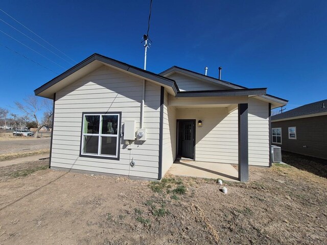 rear view of house featuring cooling unit and a patio area