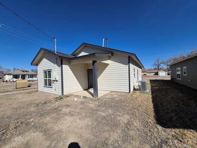 rear view of house with cooling unit