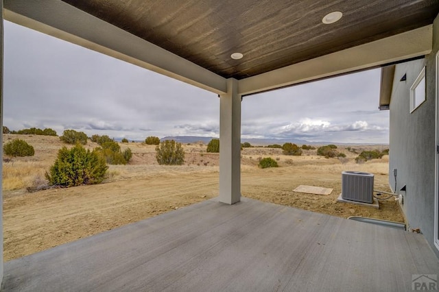 view of patio / terrace featuring cooling unit and a rural view