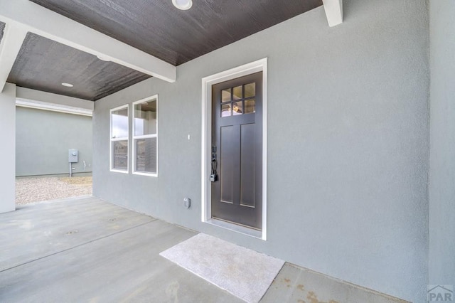 view of exterior entry with stucco siding