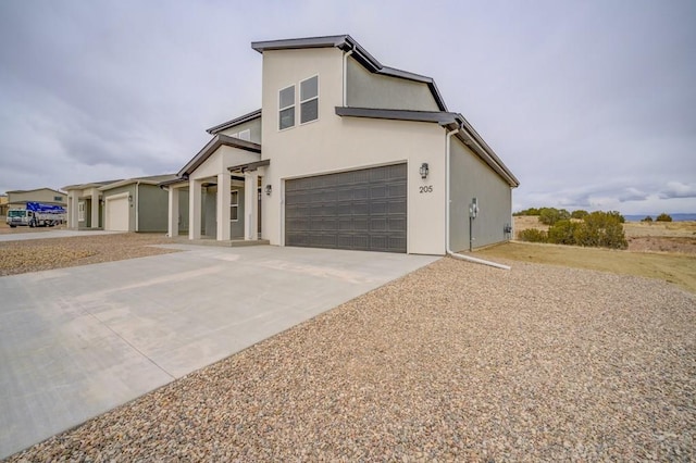 view of front of home featuring concrete driveway and stucco siding