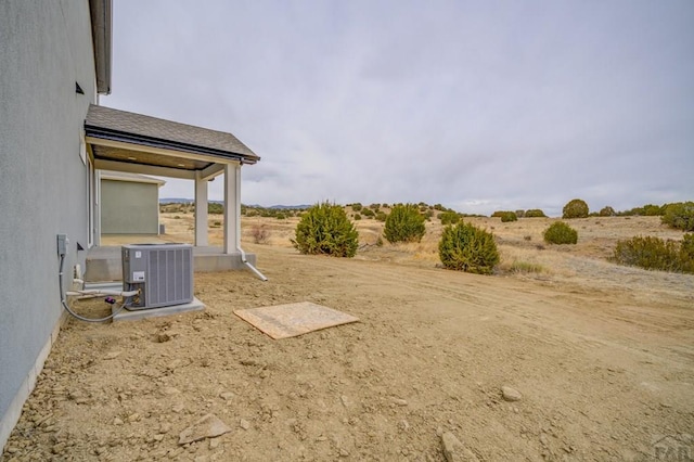 view of yard featuring central air condition unit