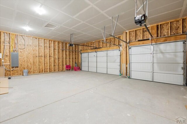 garage featuring electric panel and a garage door opener