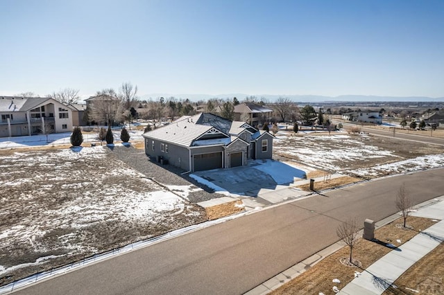 snowy aerial view featuring a residential view