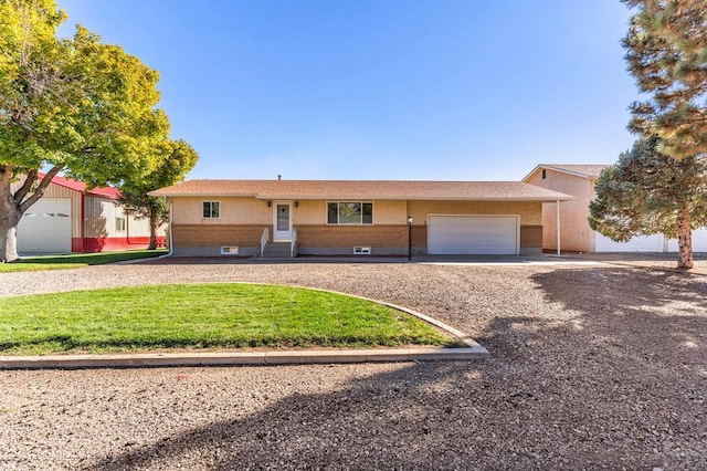 1510 24 1/4 Ln, Pueblo, CO 81006 - ranch-style house with an attached garage, a front lawn, driveway, and entry steps