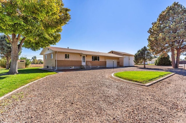 1510 24 1/4 Ln, Pueblo, CO 81006 - single story home with driveway, a front lawn, and an attached garage
