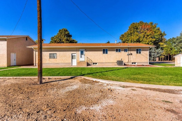 1510 24 1/4 Ln, Pueblo, CO 81006 - back of property featuring entry steps, central air condition unit, and a yard