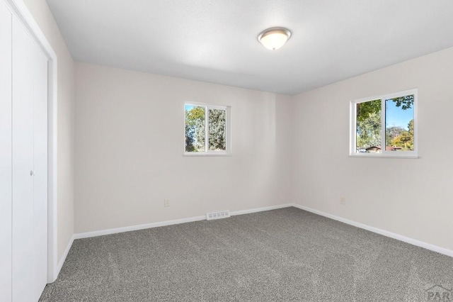 1510 24 1/4 Ln, Pueblo, CO 81006 - empty room featuring plenty of natural light, carpet flooring, and baseboards
