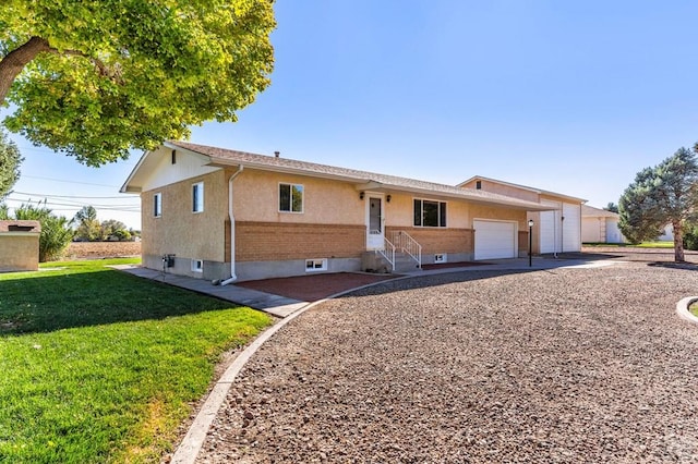 1510 24 1/4 Ln, Pueblo, CO 81006 - ranch-style home featuring a front yard, a garage, entry steps, and driveway