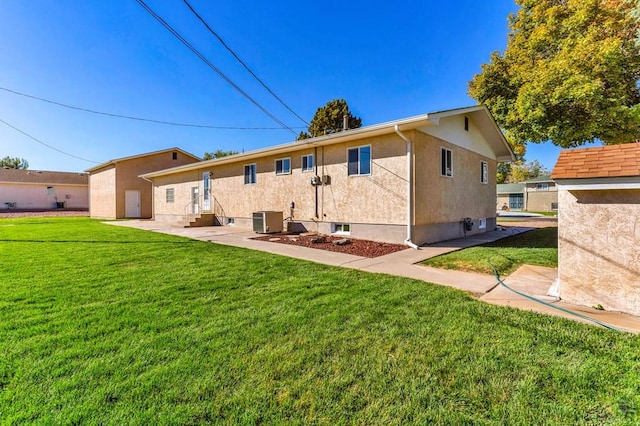1510 24 1/4 Ln, Pueblo, CO 81006 - rear view of property with a lawn, central air condition unit, and stucco siding