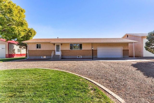 1510 24 1/4 Ln, Pueblo, CO 81006 - single story home with a garage, gravel driveway, entry steps, and a front yard