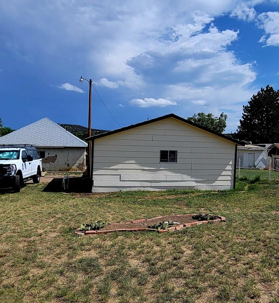 620 W 4th St, Walsenburg, CO 81089 - view of property exterior featuring a lawn