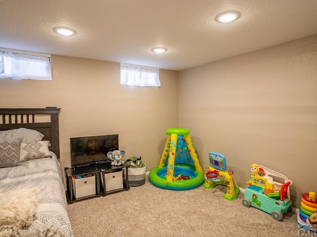 carpeted bedroom with a textured ceiling