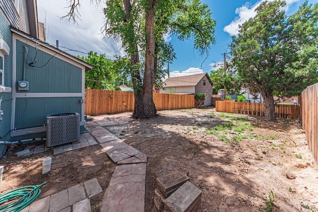 view of yard with cooling unit and a fenced backyard