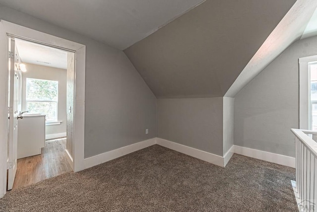 bonus room with baseboards, carpet floors, and vaulted ceiling