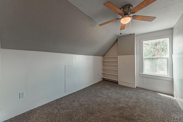 additional living space featuring carpet floors, lofted ceiling, and a ceiling fan