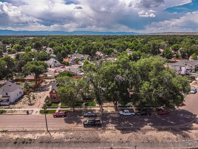 bird's eye view with a wooded view