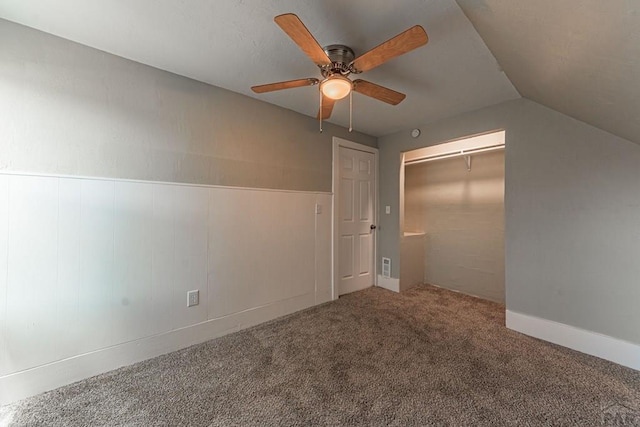 spare room featuring lofted ceiling, a ceiling fan, and carpet floors