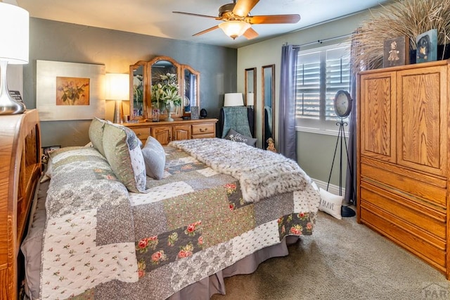 carpeted bedroom with a ceiling fan and baseboards