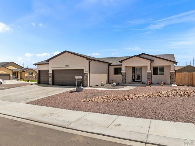 1700 Kingfisher Ln, Pueblo, CO 81008 - single story home with stone siding, a garage, concrete driveway, and stucco siding