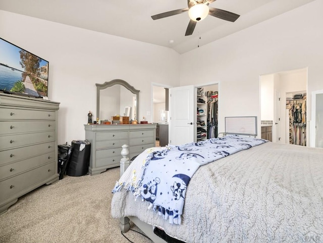 1700 Kingfisher Ln, Pueblo, CO 81008 - bedroom featuring a walk in closet, light colored carpet, a closet, connected bathroom, and ceiling fan