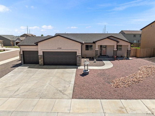 1700 Kingfisher Ln, Pueblo, CO 81008 - single story home featuring a garage, stucco siding, driveway, stone siding, and a shingled roof