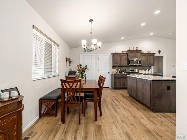 1700 Kingfisher Ln, Pueblo, CO 81008 - dining room with light wood-style flooring, a chandelier, recessed lighting, and lofted ceiling