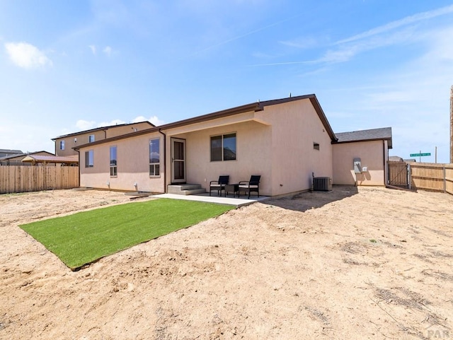 1700 Kingfisher Ln, Pueblo, CO 81008 - rear view of house featuring stucco siding, a patio, and cooling unit