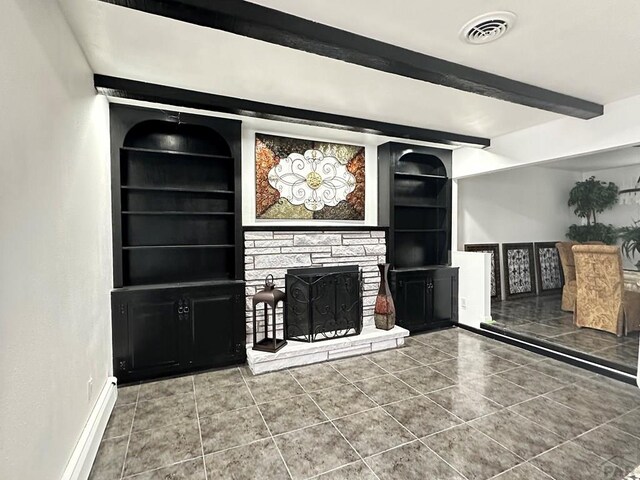 unfurnished living room featuring a fireplace, visible vents, built in features, baseboards, and beamed ceiling