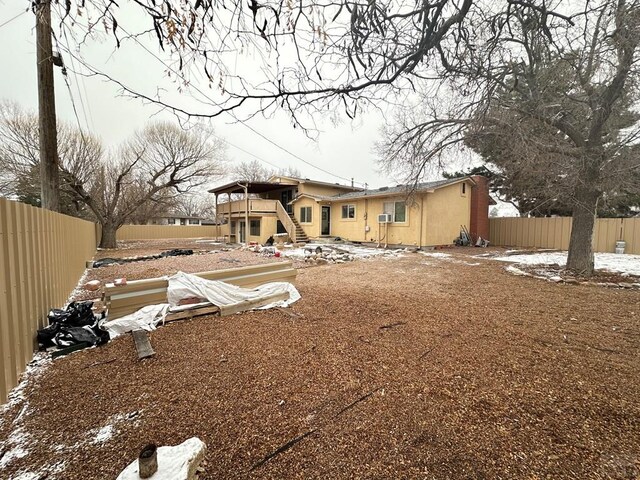 back of property featuring fence private yard and stairs