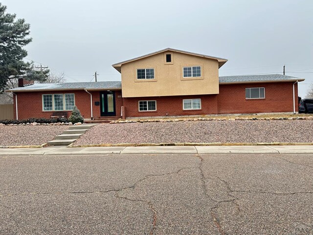 tri-level home with brick siding