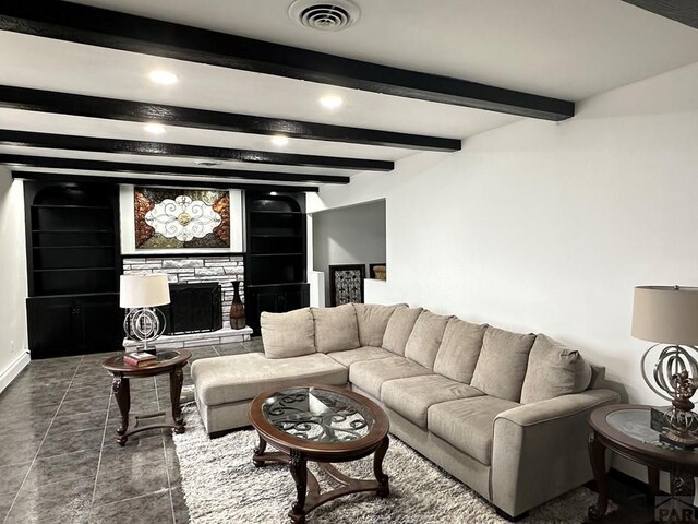 living room featuring recessed lighting, dark tile patterned flooring, a fireplace, visible vents, and beamed ceiling