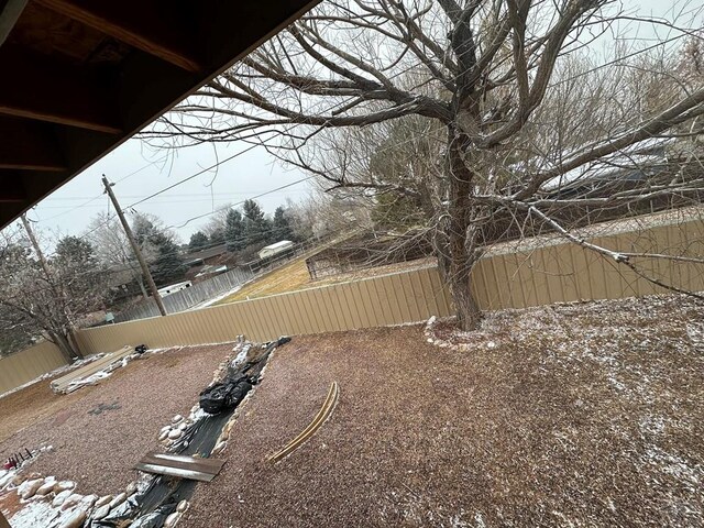 yard covered in snow with fence