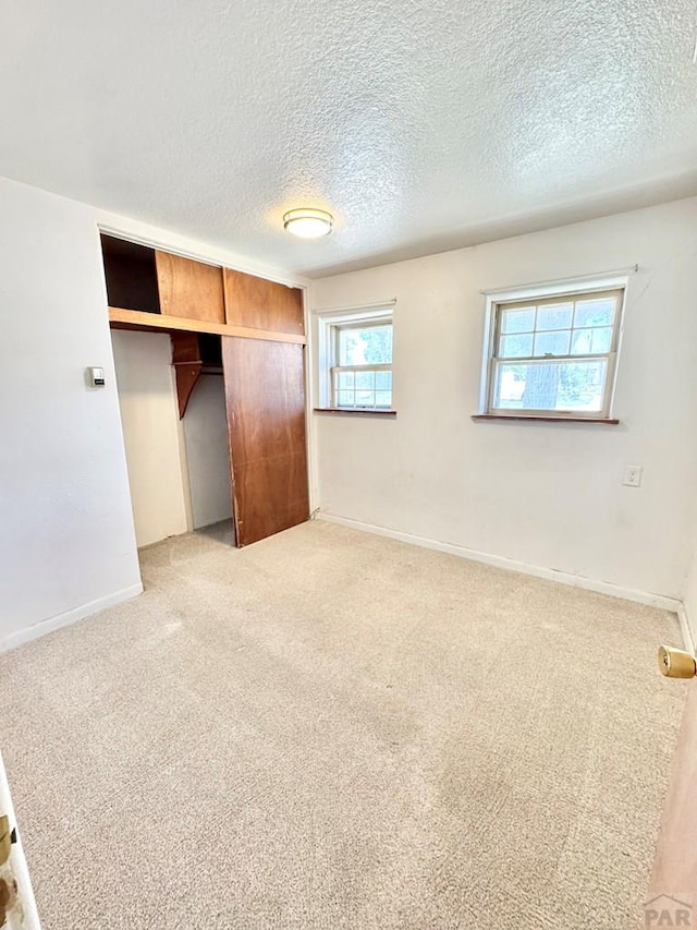 209 Beymer, Cheraw, CO 81030 - unfurnished bedroom with light carpet, a textured ceiling, and a closet