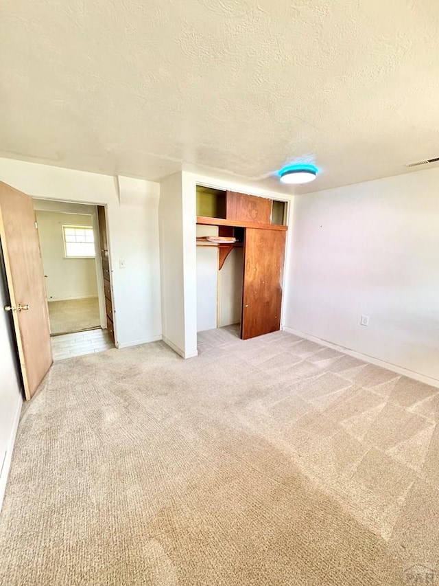 209 Beymer, Cheraw, CO 81030 - unfurnished bedroom with a textured ceiling, light carpet, and a closet