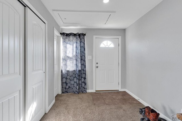 carpeted entrance foyer with baseboards