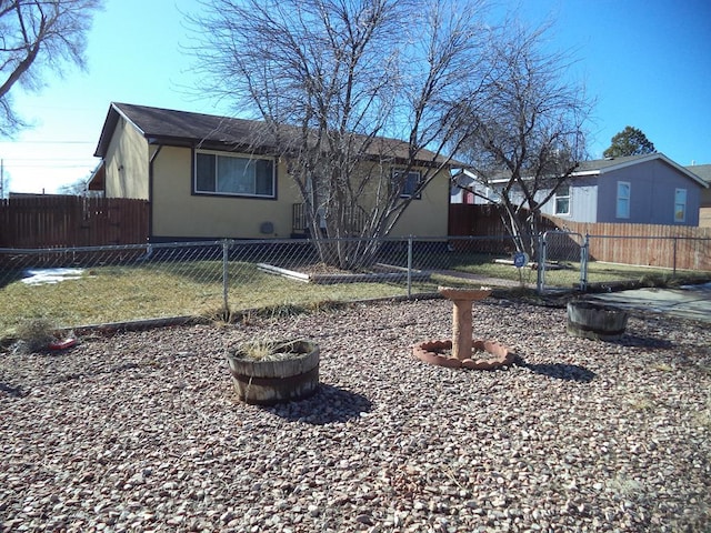 back of house featuring fence private yard