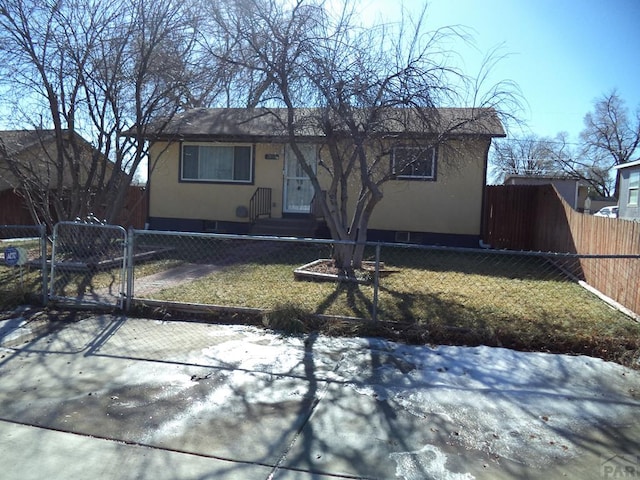 single story home with a front lawn, a fenced front yard, a gate, and stucco siding