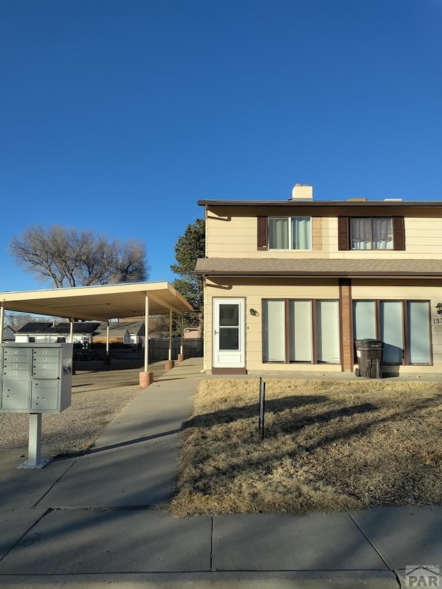 view of front of home with a carport