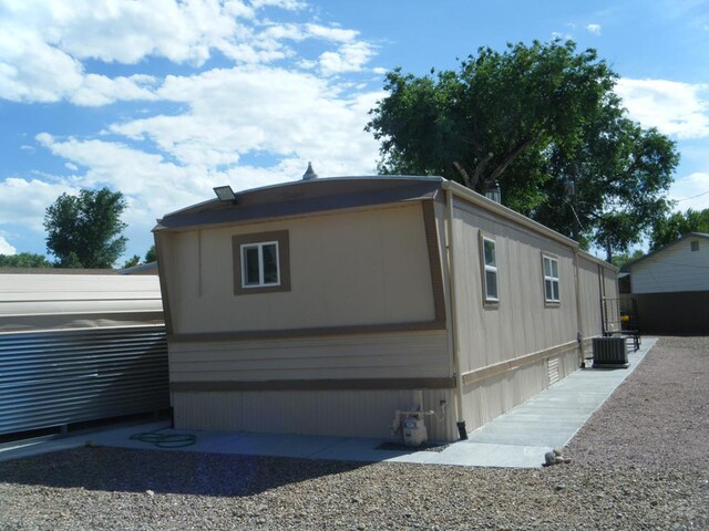 view of side of home featuring cooling unit