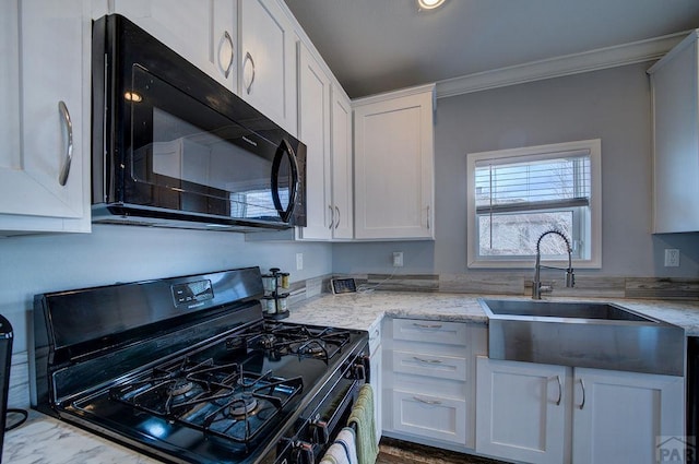 kitchen featuring ornamental molding, white cabinetry, a sink, light stone countertops, and black appliances