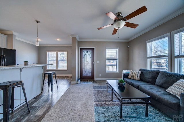 living area with ceiling fan, ornamental molding, dark wood-style flooring, and baseboards