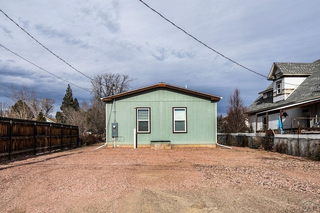 back of house with fence