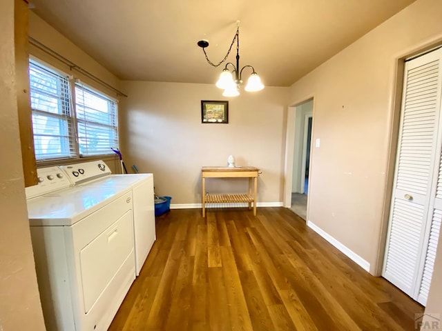 1624 Garwood Dr, Pueblo, CO 81005 - laundry area featuring washer and dryer, wood finished floors, and a chandelier