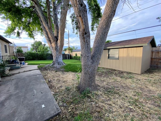 1624 Garwood Dr, Pueblo, CO 81005 - fenced backyard featuring an outbuilding and a patio area