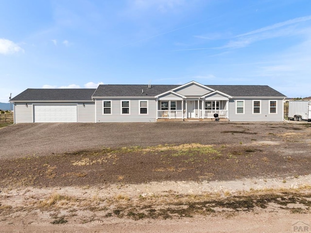 single story home with a garage and a porch