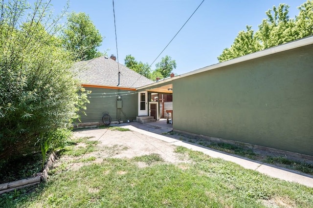 view of yard featuring entry steps and a patio