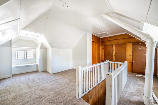 bonus room featuring vaulted ceiling, carpet flooring, and baseboards