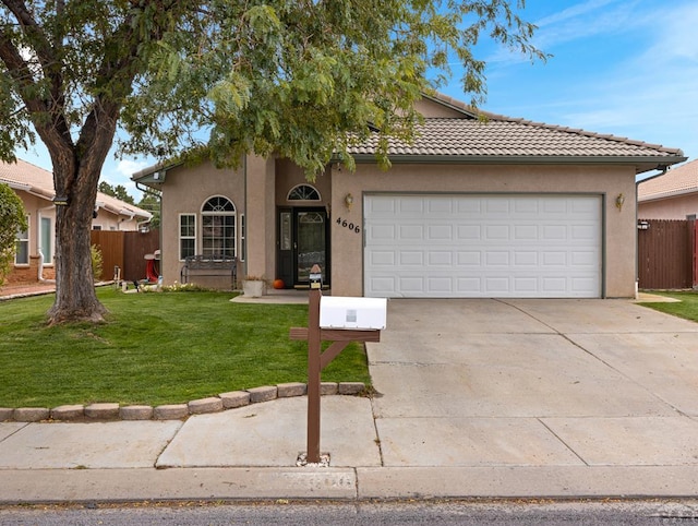 ranch-style house with driveway, a front lawn, fence, and stucco siding